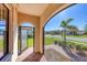 Screened porch with brick flooring and view of the community at 24176 Spartina Dr, Venice, FL 34293