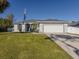 Attractive curb appeal with a large front yard and a two-car garage at 2480 Soprano Ln, North Port, FL 34286