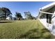 Spacious backyard with a large grassy area, perfect for outdoor activities at 3181 Nekoosa St, North Port, FL 34287