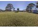Large grassy backyard with mature trees and privacy fencing at 3181 Nekoosa St, North Port, FL 34287