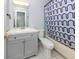 Clean bathroom with gray vanity, shower/tub combo, and patterned curtain at 3181 Nekoosa St, North Port, FL 34287