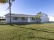 Ranch style home with gray exterior, attached garage, and lush green lawn at 3181 Nekoosa St, North Port, FL 34287