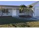 Newly renovated home with gray exterior, palm trees, and a well-maintained lawn at 3181 Nekoosa St, North Port, FL 34287
