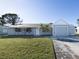 Ranch-style house with gray exterior, attached garage, and a wide driveway at 3181 Nekoosa St, North Port, FL 34287