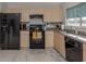 Modern kitchen with black appliances and light wood cabinets at 3181 Nekoosa St, North Port, FL 34287