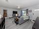 Spacious living room with gray sofa and wood flooring at 3181 Nekoosa St, North Port, FL 34287