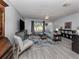 Living room with gray walls, comfy seating, and a large TV at 3181 Nekoosa St, North Port, FL 34287