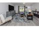 Spacious living room with gray walls, plush seating, and a large area rug at 3181 Nekoosa St, North Port, FL 34287