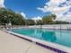 Community swimming pool with lounge chairs and surrounding trees at 3181 Nekoosa St, North Port, FL 34287