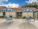 Community pool area with blue umbrellas and seating at 3181 Nekoosa St, North Port, FL 34287