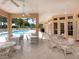 Covered patio overlooking the community pool with ample seating at 335 Rio Terra, Venice, FL 34285