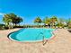 Community pool with lounge chairs and palm trees at 3648 Pebble Ter, Punta Gorda, FL 33980