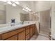 Double vanity bathroom with a large shower and updated fixtures at 3897 Fairway Dr, North Port, FL 34287