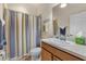 Clean bathroom with striped shower curtain and wood vanity at 3897 Fairway Dr, North Port, FL 34287