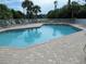 Refreshing community pool with brick patio at 3897 Fairway Dr, North Port, FL 34287