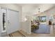 Bright and airy entryway with a view into a living room with a tiled floor and access to a lanai at 3897 Fairway Dr, North Port, FL 34287
