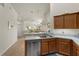 Kitchen boasts a dishwasher, sink, and view into adjacent living space at 3897 Fairway Dr, North Port, FL 34287
