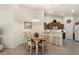 Kitchen with wooden cabinets, a breakfast bar and view into the dining area at 3897 Fairway Dr, North Port, FL 34287