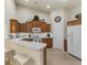 Modern kitchen with wood cabinets, stainless steel appliances, and a breakfast bar at 3897 Fairway Dr, North Port, FL 34287