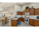 Eat-in kitchen featuring wood cabinets, ample counter space, and a dining area at 3897 Fairway Dr, North Port, FL 34287