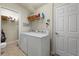 Laundry room with washer, dryer, and shelving at 3897 Fairway Dr, North Port, FL 34287