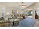 Living room featuring a comfortable seating arrangement, tiled floors, and access to a lanai at 3897 Fairway Dr, North Port, FL 34287
