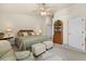 Main bedroom with king-size bed, ceiling fan, and built-in shelving at 3897 Fairway Dr, North Port, FL 34287