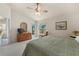 Main bedroom features a king bed, private access to the patio, and a dresser at 3897 Fairway Dr, North Port, FL 34287
