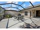 Screened patio with seating area and grill at 3897 Fairway Dr, North Port, FL 34287