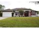 Single-story home with a two-car garage and landscaped lawn at 4010 S Cranberry Blvd, North Port, FL 34286