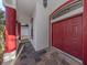 Elegant entryway with red double doors and red columns at 4010 S Cranberry Blvd, North Port, FL 34286