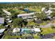 Aerial showing condo building, pool, and surrounding golf course at 437 Cerromar Ln # 515, Venice, FL 34293