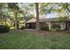 Spacious backyard with lush grass and mature trees at 4765 Oak Forest W Dr # 47, Sarasota, FL 34231