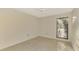 Small bedroom with tiled floors and large window at 4765 Oak Forest W Dr # 47, Sarasota, FL 34231