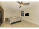 Bedroom with tile floors, ceiling fan, and sliding glass doors to patio at 4765 Oak Forest W Dr # 47, Sarasota, FL 34231