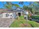 Front view of condo with white exterior, two-car garage, and paver driveway at 4765 Oak Forest W Dr # 47, Sarasota, FL 34231