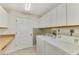 Laundry room with washer, dryer, and built-in cabinets at 4765 Oak Forest W Dr # 47, Sarasota, FL 34231