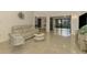 Bright living room featuring a comfy sofa, accent chair, and sliding glass doors leading to backyard at 4765 Oak Forest W Dr # 47, Sarasota, FL 34231