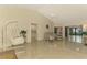 Living room with vaulted ceiling, tile floors, and access to the patio at 4765 Oak Forest W Dr # 47, Sarasota, FL 34231