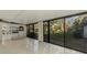 Sunroom with large windows, tiled floor, and serene view at 4765 Oak Forest W Dr # 47, Sarasota, FL 34231