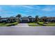 Single-story home with tile roof, gray garage door, and landscaped yard at 5307 Cicerone St, Sarasota, FL 34238