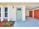 Close-up of the light teal front door with a glass panel and a wreath at 58 Circlewood Dr # A1-5, Venice, FL 34293