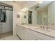 Double vanity bathroom with a large walk-in shower and ample closet space at 5837 Semolino St, Nokomis, FL 34275