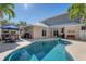 Private backyard features a beautiful pool, patio area, and mature landscaping at 6405 Gulf Dr, Holmes Beach, FL 34217
