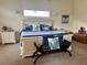 Bedroom with blue and white decor, decorative pillows, and bench at 6405 Gulf Dr, Holmes Beach, FL 34217