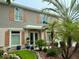 Two-story exterior features light brown shake siding, copper-colored shutters and professional landscaping at 6405 Gulf Dr, Holmes Beach, FL 34217
