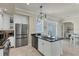 Well-lit kitchen with an island, black countertops, and stainless steel appliances at 6405 Gulf Dr, Holmes Beach, FL 34217