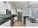 Modern kitchen with stainless steel appliances and white cabinets at 6405 Gulf Dr, Holmes Beach, FL 34217