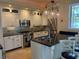 Contemporary kitchen with stainless appliances, black countertops, and stylish white cabinetry at 6405 Gulf Dr, Holmes Beach, FL 34217