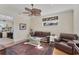 Well-lit living room with neutral walls features a leather sofa and light wood flooring at 6405 Gulf Dr, Holmes Beach, FL 34217